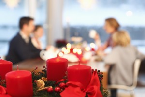 Close up of Christmas candles with family in the background