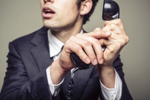 Businessman covering the phone