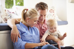 Parents Reading Book To Young Son