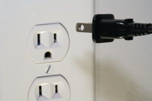 plug going into electrical outlet